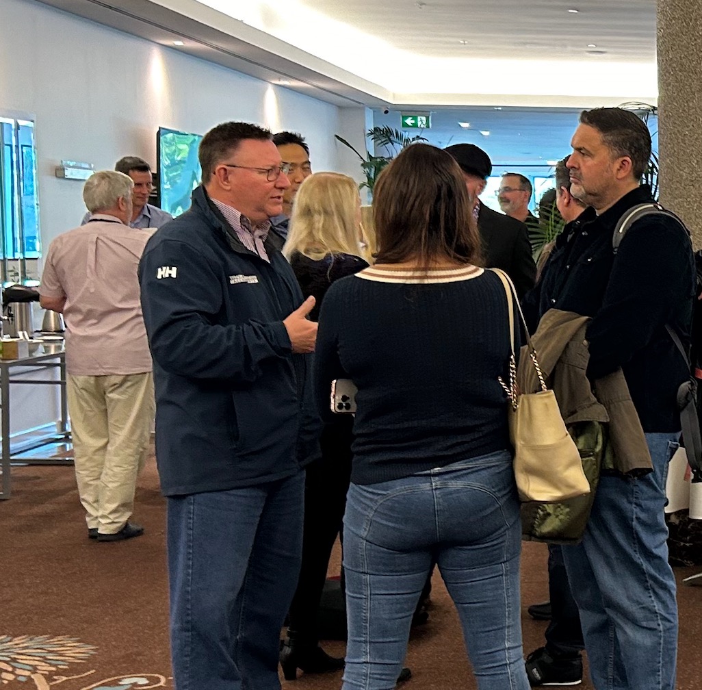Attendees networking at a previous New Era Summit event